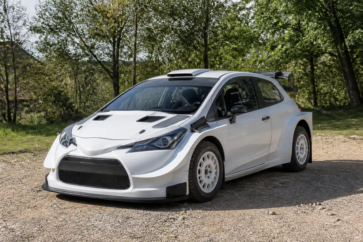 Une voiture de rallye blanche à vendre stationnée sur un chemin de gravier